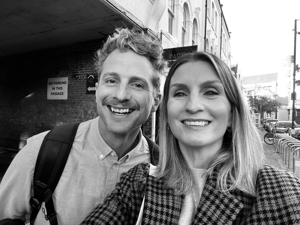 Black and white selfie of Rik Turner and Hannah Harris outdoors on a London street